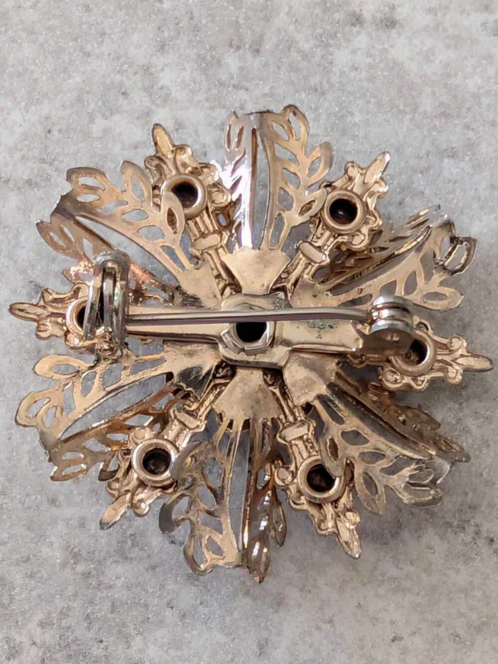 Gold-Tone Filigree Floral Starburst Brooch with Black Enamel and Clear Crystals